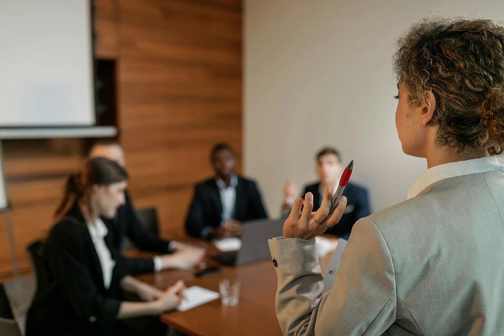 A team discussing hiring needs around a conference table